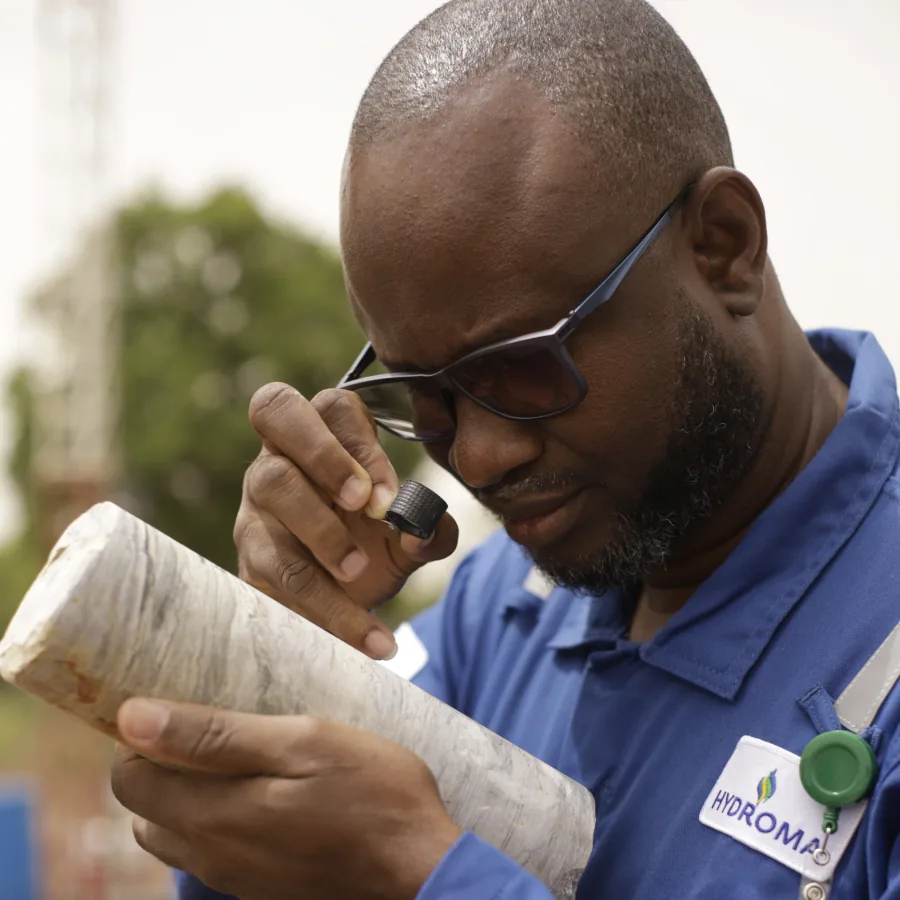 Hydroma geologist examining a drill core